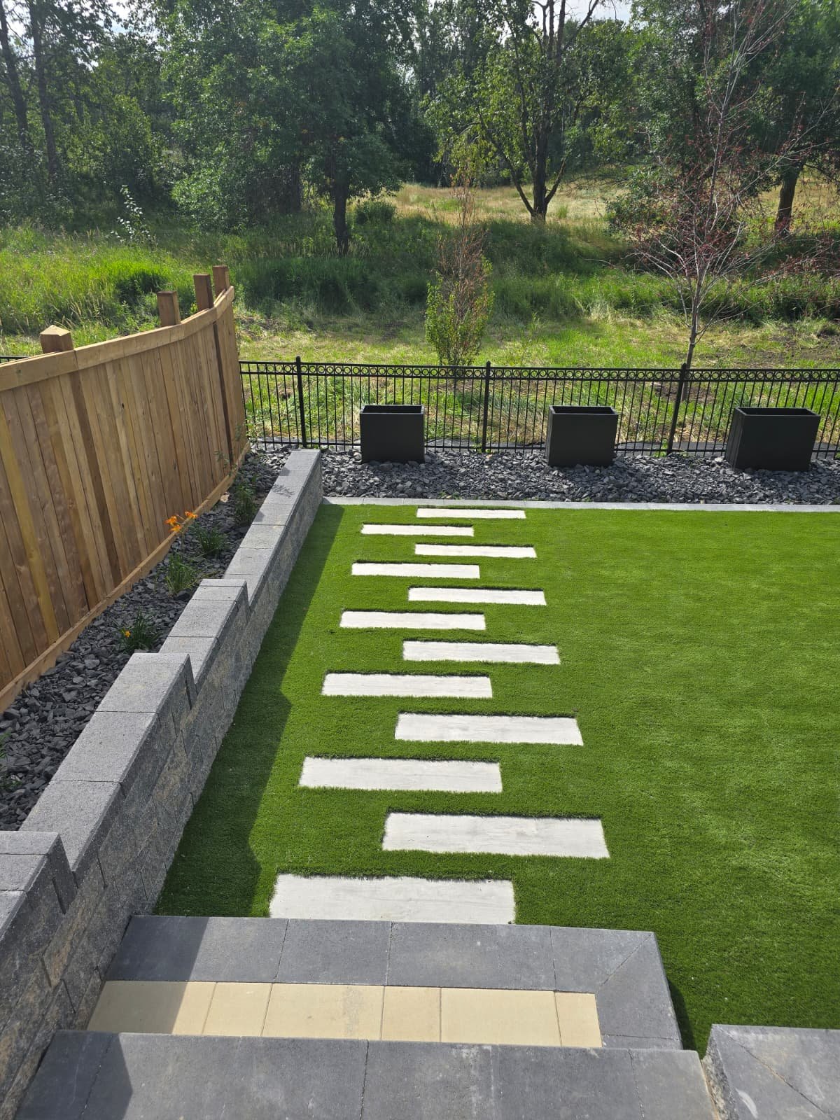Sod with stone retaining wall and stepping stones — Edmonton