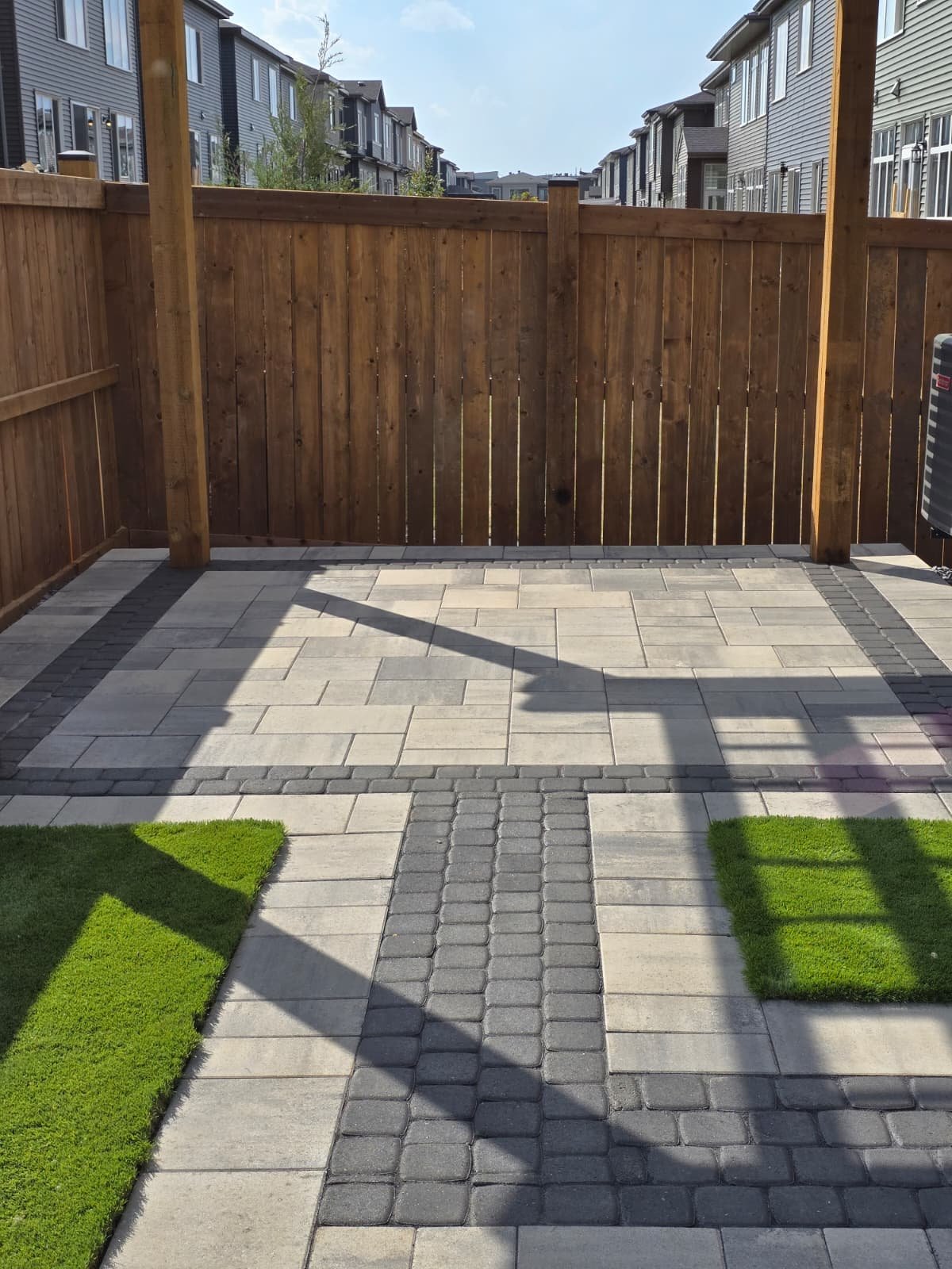 Two-tone paver patio with decorative border — Edmonton