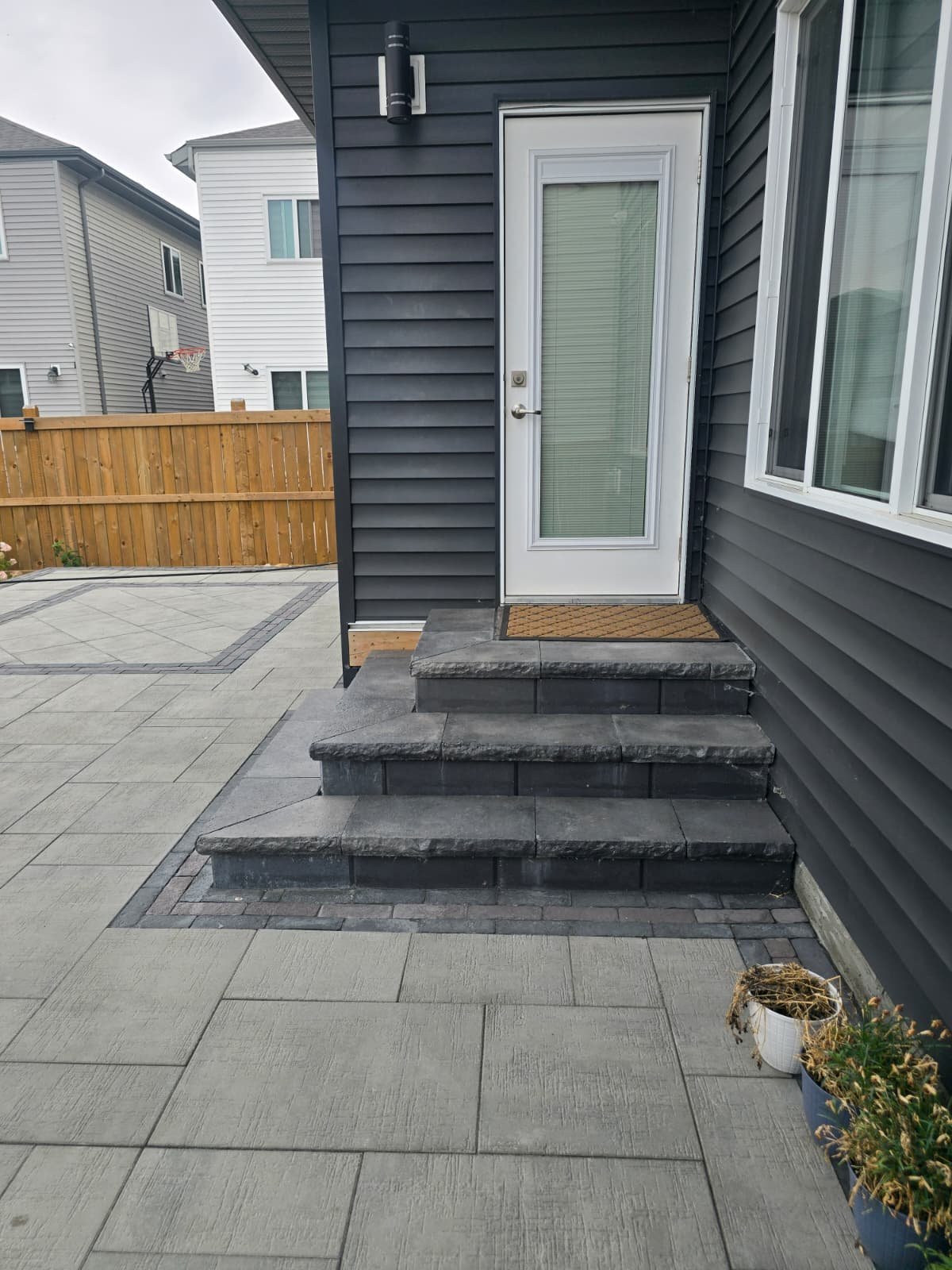 Dark tone stone steps leading to patio — Edmonton